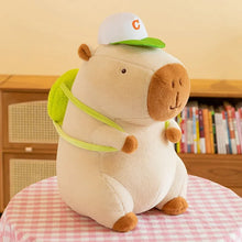 Load image into Gallery viewer, albino capybara plushie in white hat and green backpack