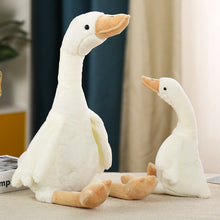 Load image into Gallery viewer, Two plush goose toys on a surface with a blurred indoor background
