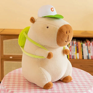 albino capybara plushie in white hat and green backpack