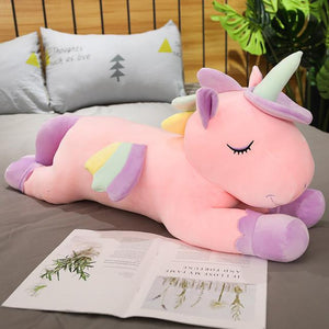Cute pink unicorn plushie having a rest
