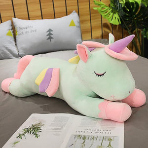Cute green unicorn plushie having a rest