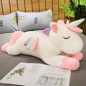 Cute white unicorn plushie having a rest