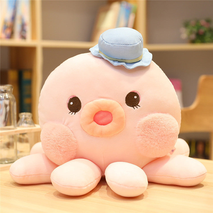 pink octopus plushie with blue hat