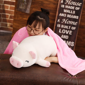girl covering pig plushie with blanket