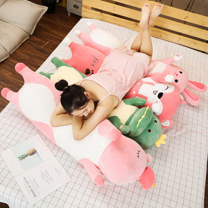 girl lying on long plushie pillows