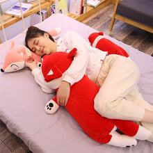 Load image into Gallery viewer, girl hugging big red fox plushie and lying on pink fox plushie