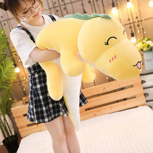 girl hugging yellow dinosaur plushie