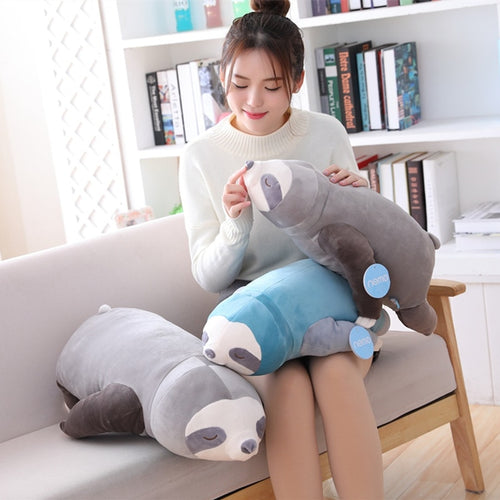 girl playing with cute grey sloth plushie and blue sloth plushie