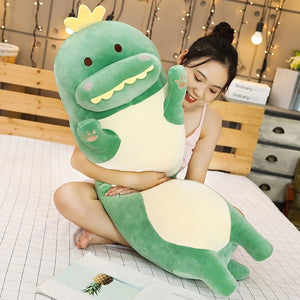 girl hugging green dinosaur bolster
