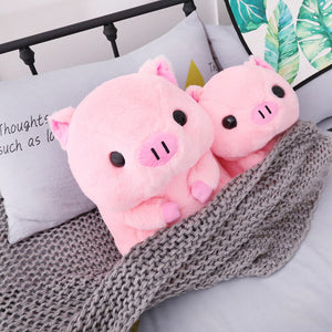 2 cute pink pig plushies laying on bed